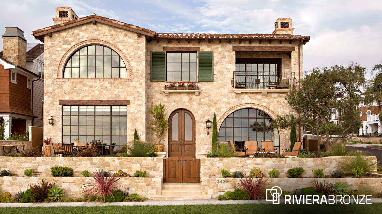 Riviera Bronze -Precision Meets Performance (2) A Mediterranean-style luxury home featuring arched and rectangular custom steel windows by Riviera Bronze